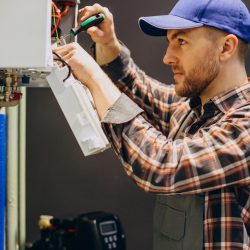 Service man adjusting house heating system